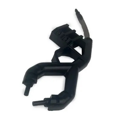 A black plastic part with tubes and a cable, isolated on a white background.