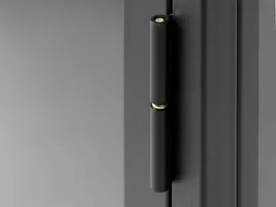 A close-up of a black metal hinge on a dark surface.