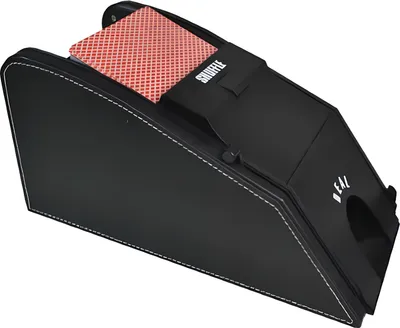 A black electronic card shuffling machine with a deck of cards partially inserted.