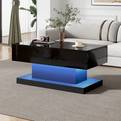 A modern living room with a black high-gloss coffee table with blue LED lighting.