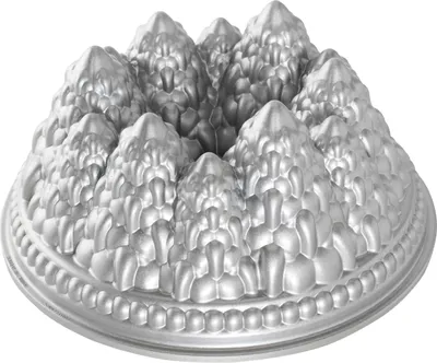 A silver-colored bundt cake pan shaped like a pine forest.