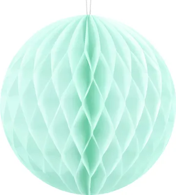 A mint green honeycomb paper ball hanging from a string against a white background.