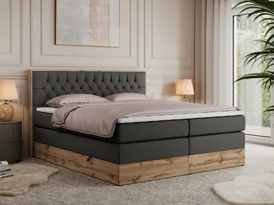A bedroom scene with a bed, nightstand, and lamp.