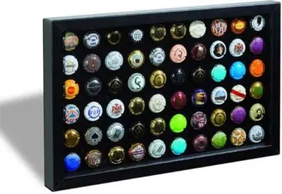 A display frame filled with many different champagne caps.