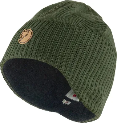 A green knitted beanie with a brown logo patch.