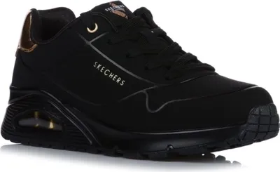A black Skechers sneaker with gold accents is shown from the side against a white background.