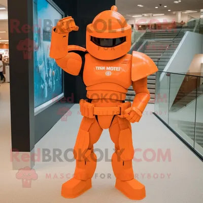 Immagine prodotto di Personaggio del costume della mascotte REDBROKOLY del soldato spartano arancione vestito con una maglietta da polo e fermacravatta