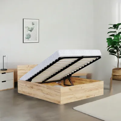 A bed frame with the mattress lifted to reveal storage space underneath.