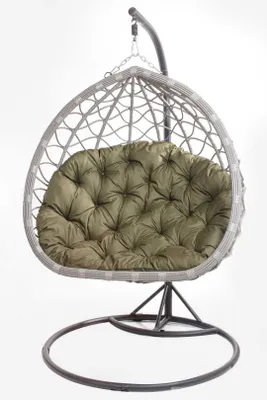 A hanging egg chair with a green cushion, shown against a white background.