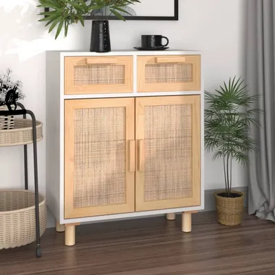 A white and wood sideboard with rattan details, placed in a room with a plant and curtains.