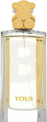 A perfume bottle with a gold bear-shaped cap.