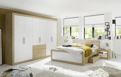A modern bedroom with a large wardrobe, bed, and nightstand.