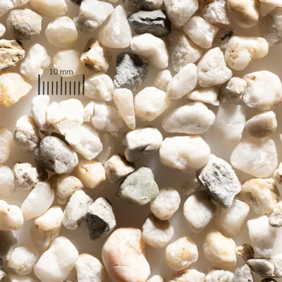 A close-up view of small, smooth pebbles and gravel of various colors and textures.