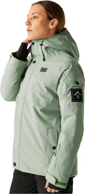 A woman wearing a green ski jacket.