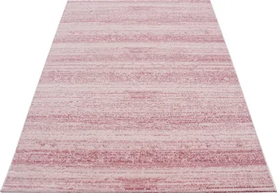 A close-up, angled view of a pink and white striped rug.