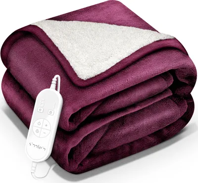 A folded burgundy electric blanket with a white sherpa lining, and a white remote control with buttons and a digital display attached by a cord.