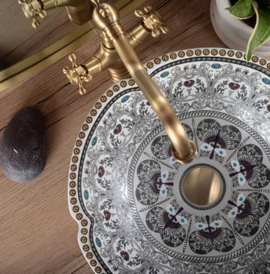 A close-up view of a decorative sink basin with a faucet.