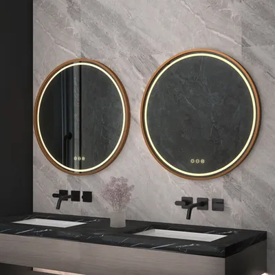 A modern bathroom vanity with two round mirrors above two sinks and black faucets.
