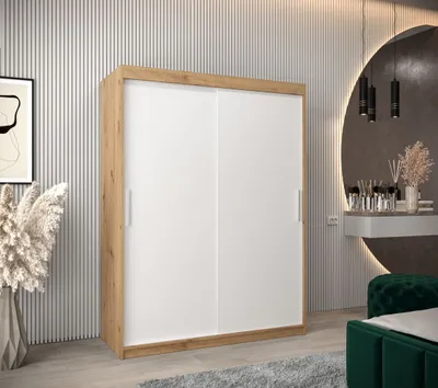 A modern bedroom setting with a sliding door wardrobe.