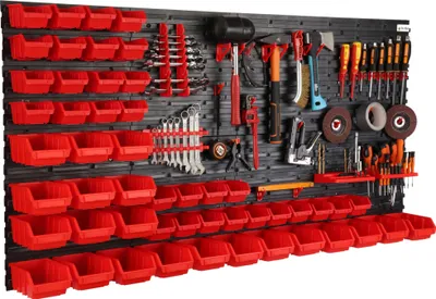 A tool wall organizer with multiple red storage bins and various tools mounted on a black pegboard.