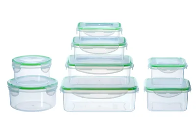 A set of clear plastic food storage containers with green lids and clasps, arranged in groups on a white background.