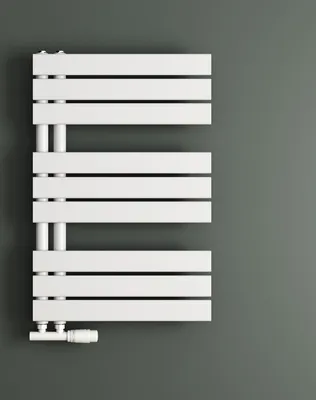 A white radiator against a gray wall.