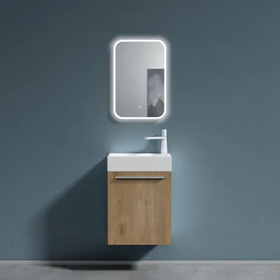 A modern bathroom vanity with a sink, faucet, mirror, and cabinet against a blue wall.