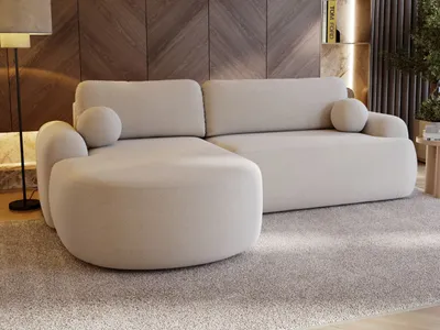 A modern beige sectional sofa is shown in a living room setting with a wooden accent wall and a plush carpet.