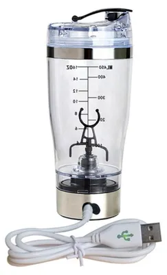 A clear, studio shot of a USB-rechargeable protein shaker bottle with a built-in mixer and a USB charging cable.