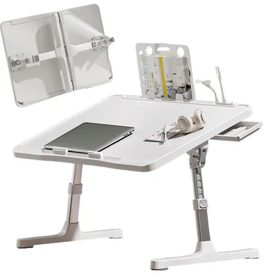 A white adjustable laptop table with a laptop, headphones, and a book on it.