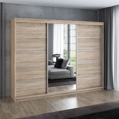 A modern sliding door wardrobe with mirrored doors, set in a room with a concrete wall and wooden floor.