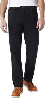 A person wearing black jeans and brown shoes, shown from the waist down against a white background.