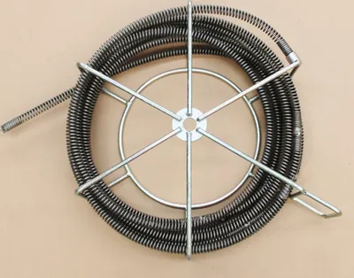 A coiled drain cleaning snake on a metal stand.