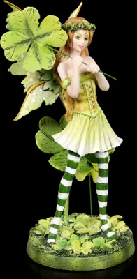 A figurine of a fairy with clover leaves and striped stockings.