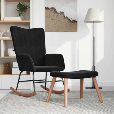A black velvet rocking chair and ottoman are placed on a rug in a room with a bookshelf and a floor lamp.