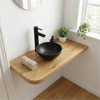 A modern bathroom sink setup with a black ceramic basin on a wooden countertop.