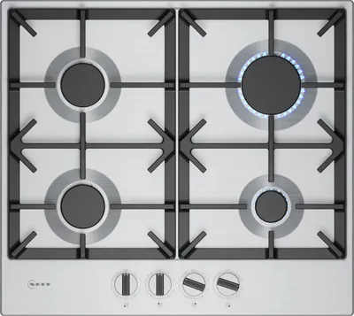 A top-down view of a gas hob with four burners, one of which is lit.