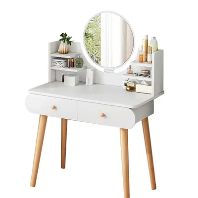 A white vanity table with wooden legs, featuring a round mirror and shelves stocked with various cosmetic products.