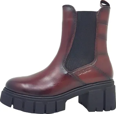 A single red leather boot with a thick black sole is shown against a white background.