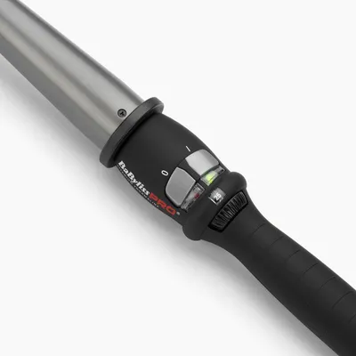Close-up of the handle and barrel of a curling iron.