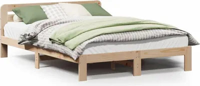 A wooden bed frame with bedding.