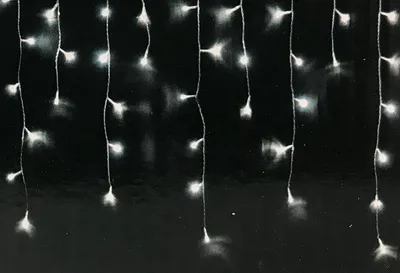 A close-up of a string of white LED lights against a black background.