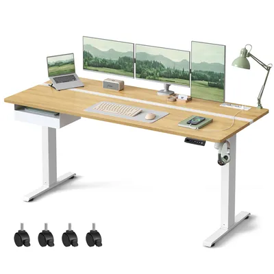 A product shot of a height-adjustable desk with multiple monitors, a laptop, and accessories.
