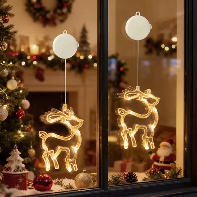 Christmas decorations in a window, including illuminated reindeer figures.