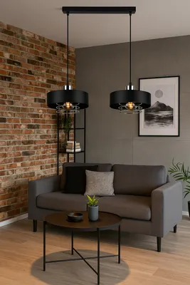 A modern living room with a grey sofa, coffee table, and brick wall.