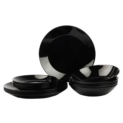 A set of black dinnerware, including plates and bowls, is neatly arranged against a white background.