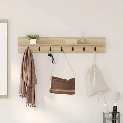 A wooden shelf with hooks mounted on a white wall, displaying a scarf, a handbag, keys, a small plant, and some decorative items.