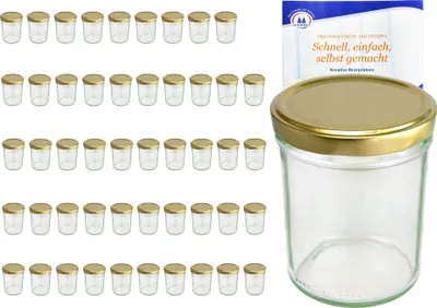A collection of small glass jars with gold lids, along with a single larger jar and a recipe booklet.