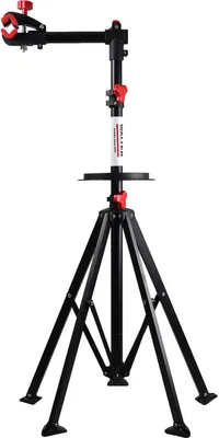 A black and red bicycle repair stand with a tripod base and a clamp for holding a bicycle frame.