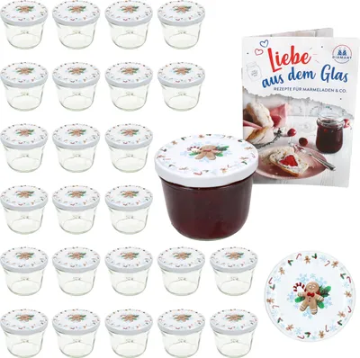 A set of glass jars with lids, a recipe book, and a decorative plate, all with a Christmas theme.